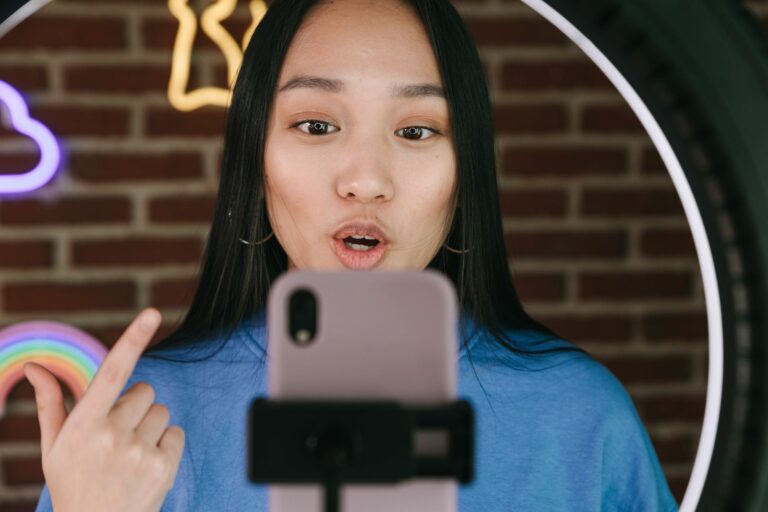 Student doing AI IELTS practice by recording a spoken answer on a smartphone for band feedback