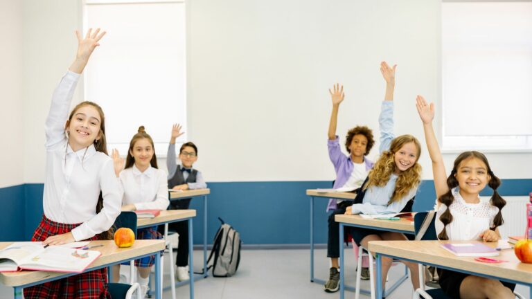 ESL students raising their hands during a fast-paced classroom warm-up activity