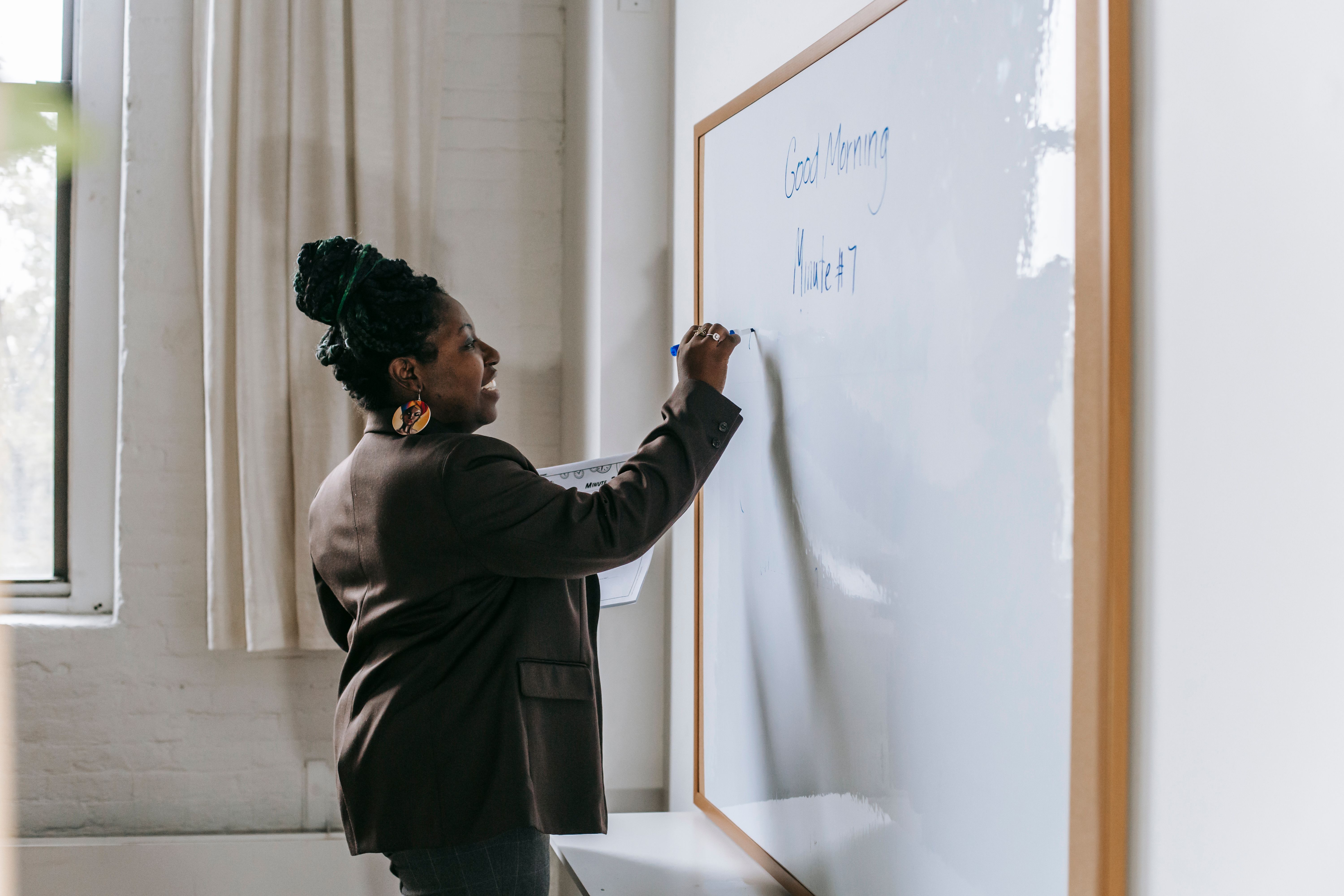 Teacher confidently writing a lesson plan, illustrating is it cheating to use AI for lesson planning answered as no when the teacher directs the process
