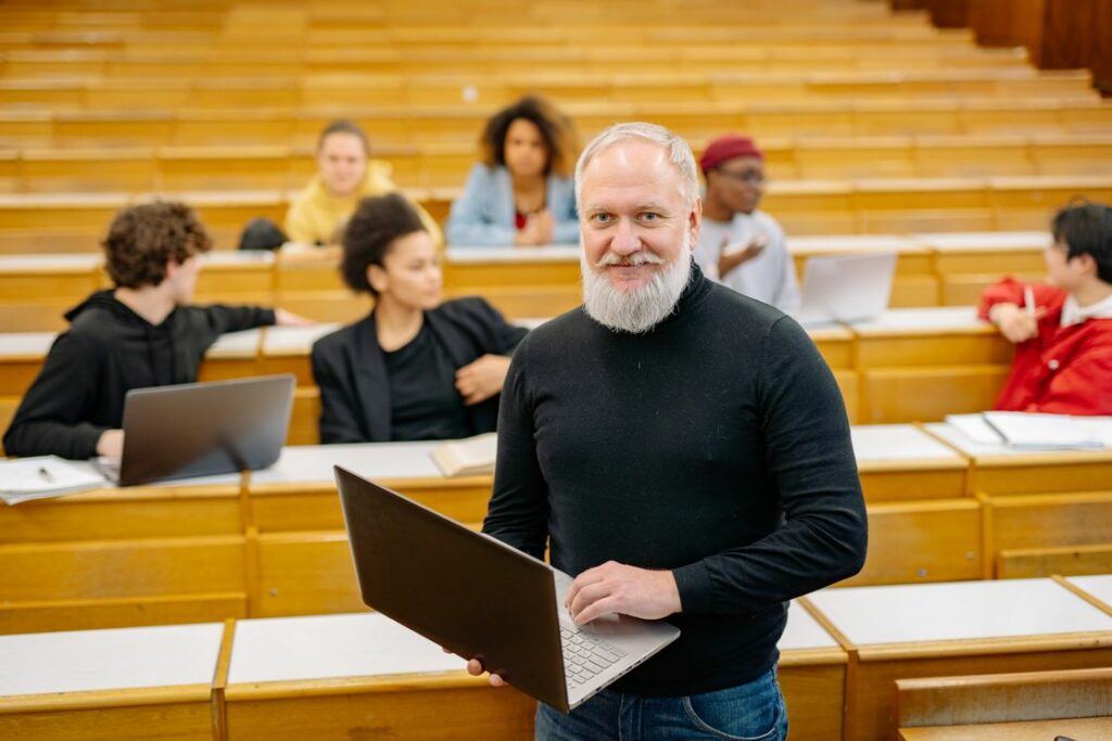 Teacher holding a laptop in a classroom while testing a free AI lesson plan generator