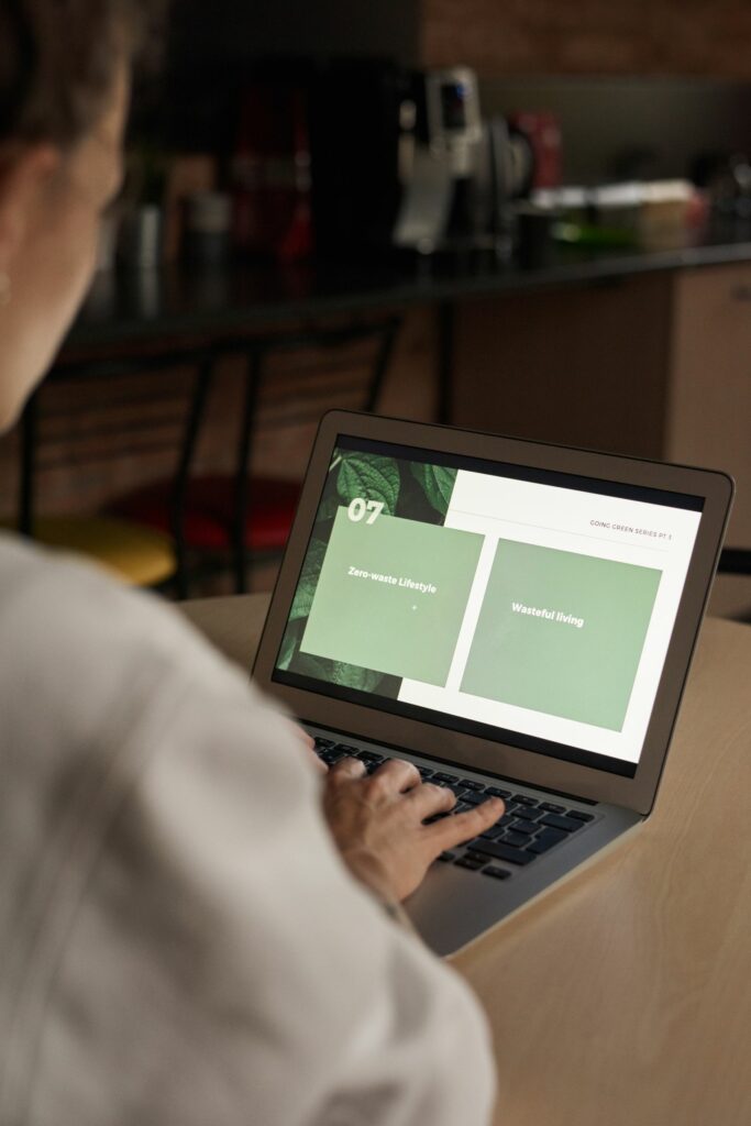 Person typing at a laptop while drafting a TEFL resume with AI tools at a desk