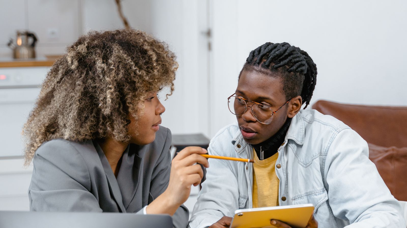 Teacher and student reviewing role cards from an AI dialogue generator for an ESL speaking lesson