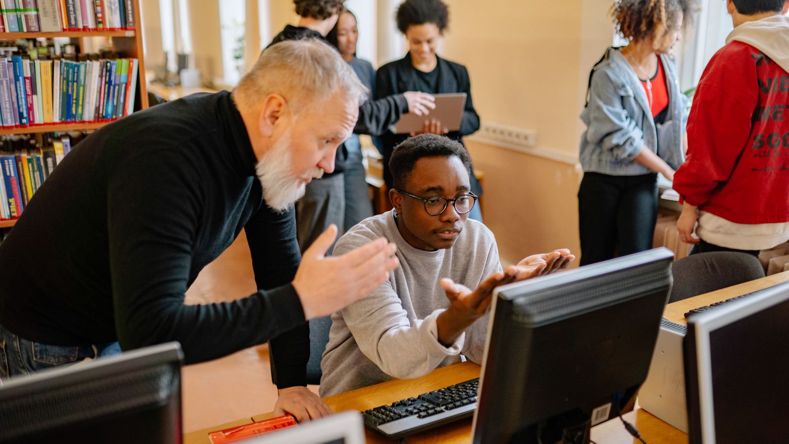 English teacher and student reviewing a Diffit generated reading passage on a computer