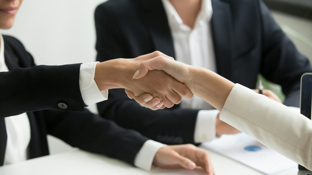 TEFL interview handshake after preparing mock interview questions and answers with AI