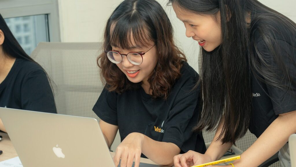 English teacher using Brisk Teaching style AI feedback while marking student work on a laptop
