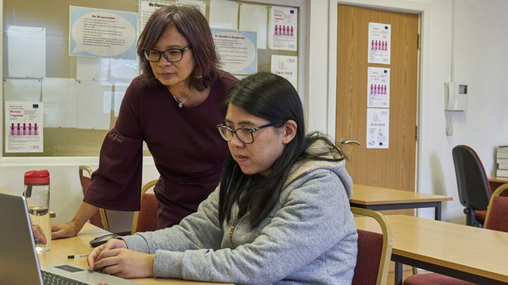 Two teachers reviewing an AI materials tool such as Diffit on a laptop