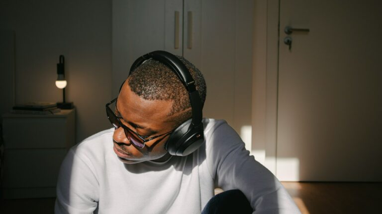 English learner doing ESL listening activities with headphones at a laptop in a quiet room