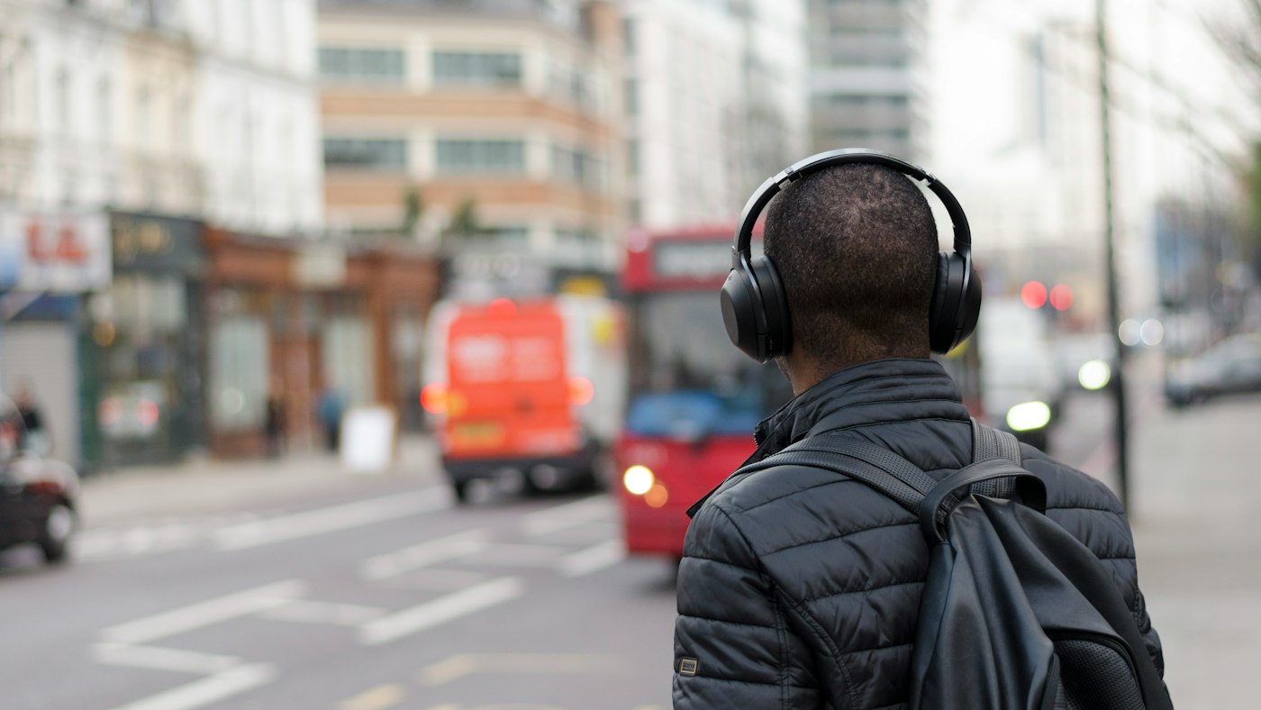 English learner using headphones for extensive listening practice outside the classroom