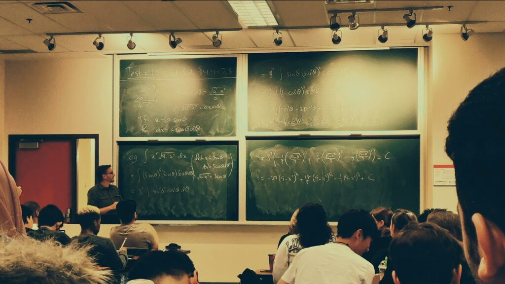 Student seated in front of a chalkboard in an English class supported by MagicSchool AI tools