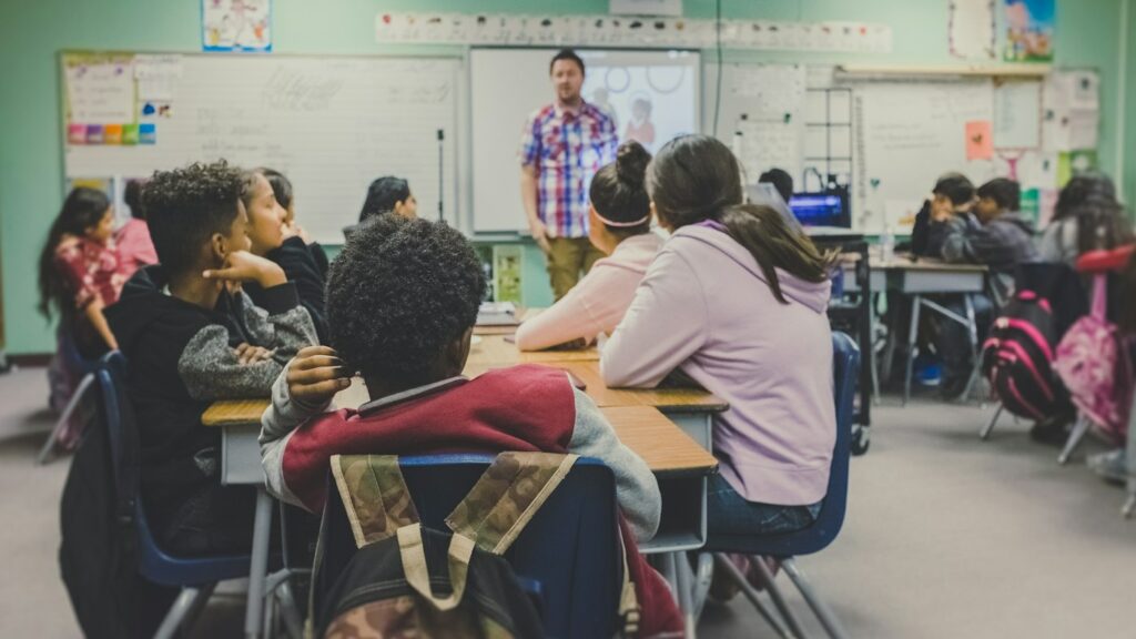 English teacher presenting to adult learners in a classroom using Twee AI lesson materials
